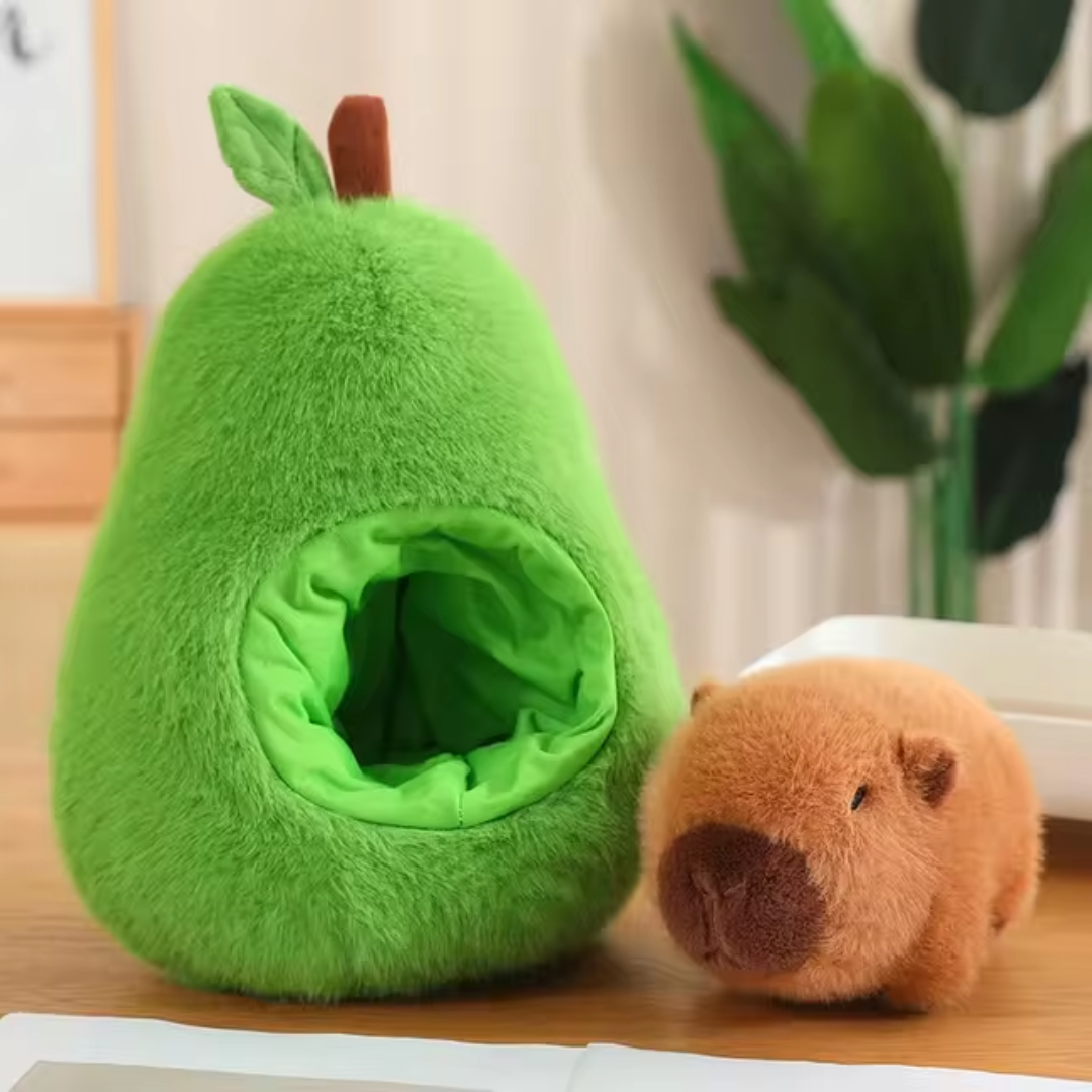 Avo Buddy™ plush set from Fluffy Haven featuring the capybara plush playfully snuggling into the avocado’s plush interior.